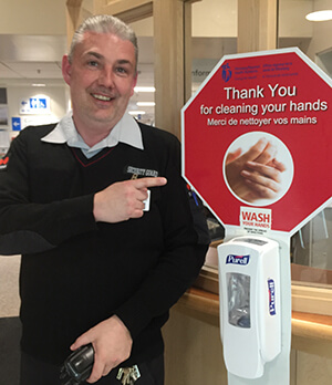 Security team member Kory Wilson is greeting and helping screen health centre guests during the COVID-19 outbreak