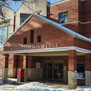 Front of Misericordia Place with snow on ground